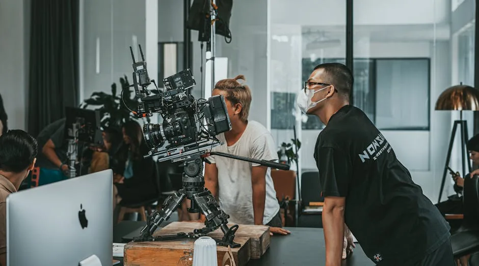 A professional film crew collaborates in a modern studio setting, focusing on high-end camera equipment.