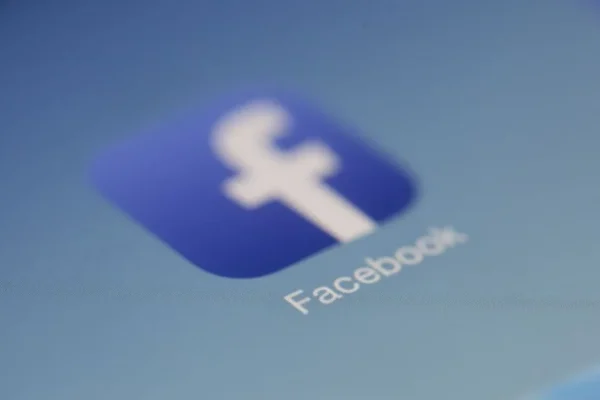Close-up view of the Facebook app logo on a digital screen with blurred background.